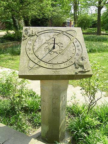 photo of a sundial on a pedestal in a garden